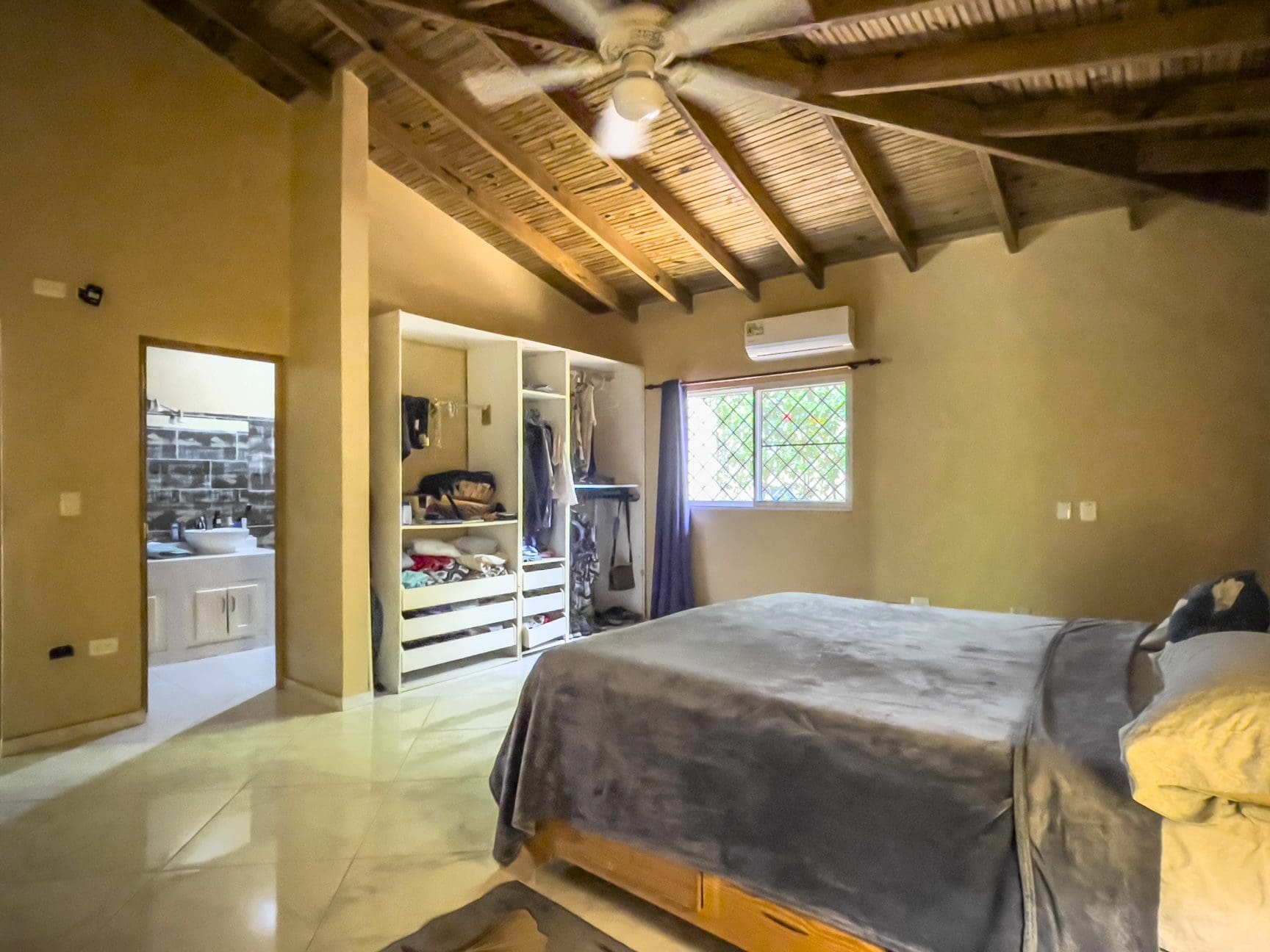 buyDRproperty Bedroom in a 3 bedroom villa for sale, featuring a wooden ceiling and walk-in closet. Sosua Real Estate