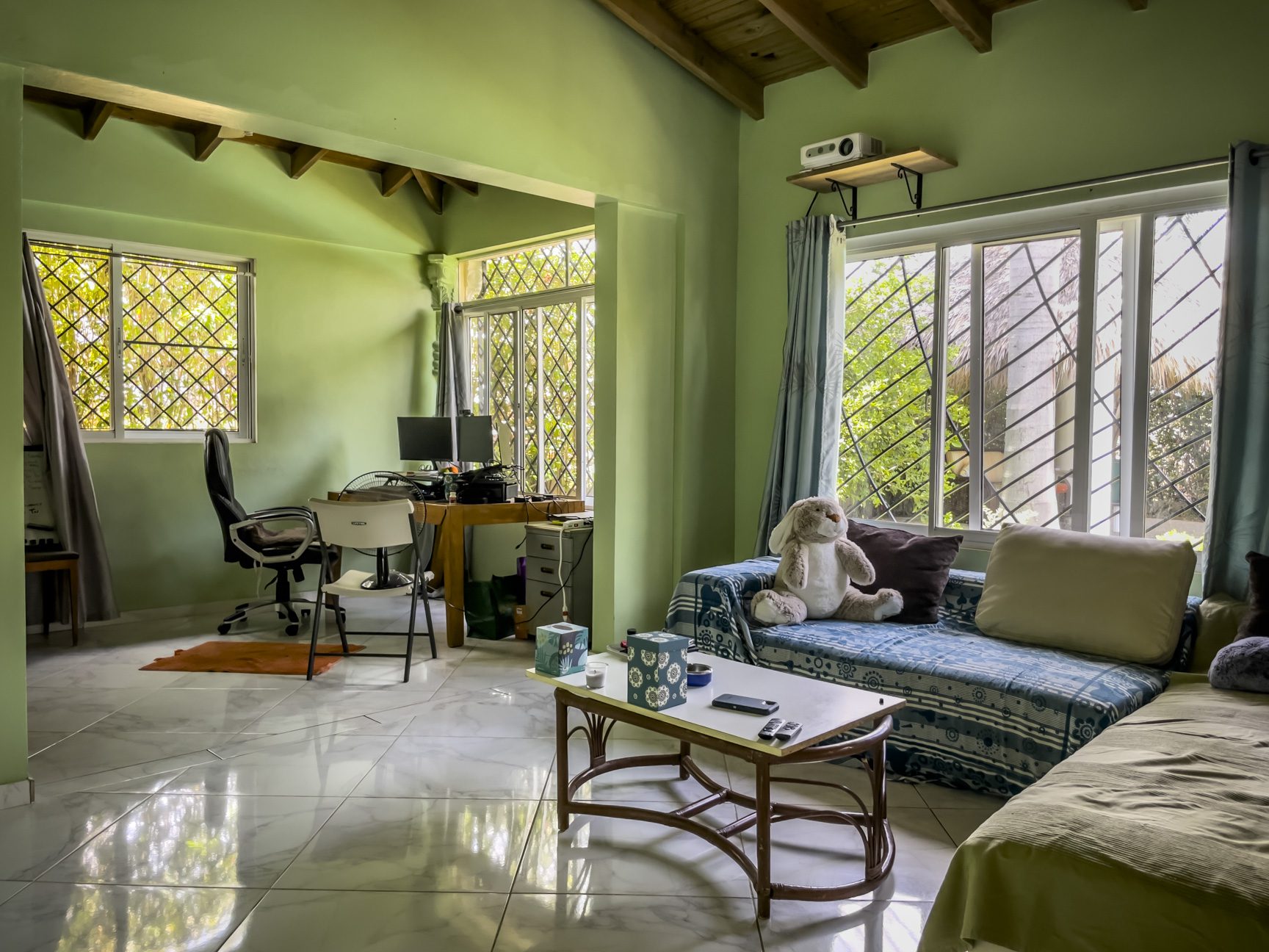 buyDRproperty Living room of a 3-bedroom villa for sale, featuring a sofa, desk, and windows. Sosua Real Estate