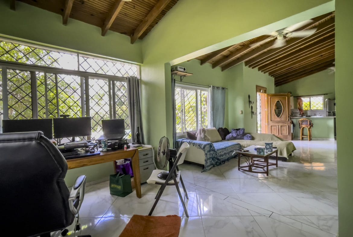 buyDRproperty Living room of a 3-bedroom villa for sale, featuring a desk, sofa, and open layout. Sosua Real Estate