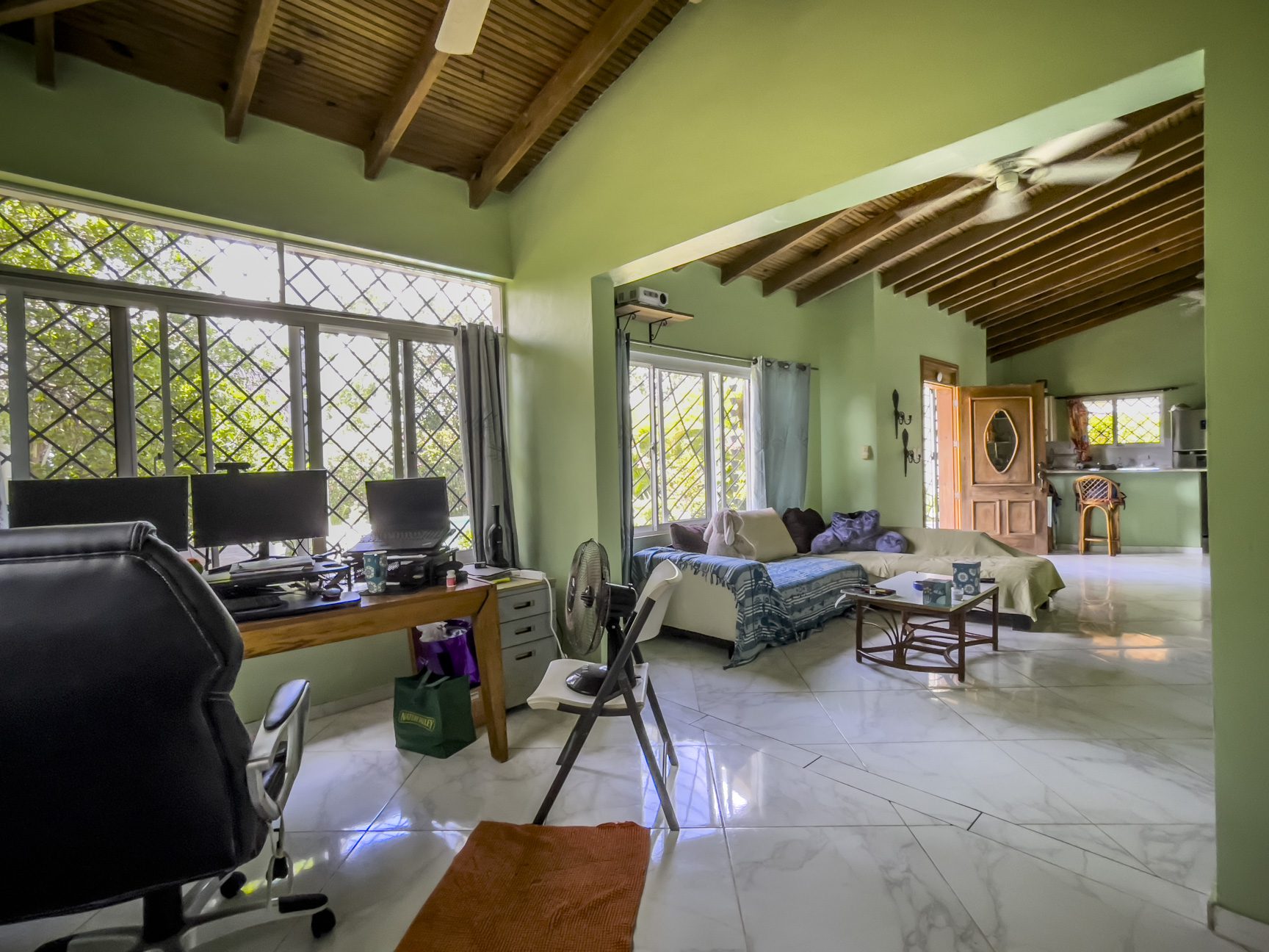 buyDRproperty Living room of a 3-bedroom villa for sale, featuring a desk, sofa, and open layout. Sosua Real Estate