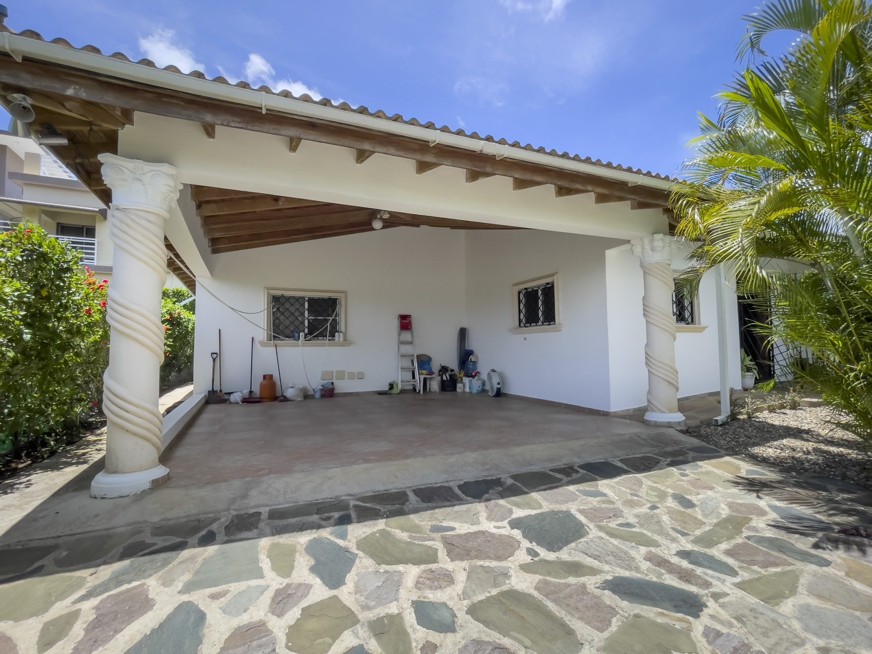 buyDRproperty For Sale 3 Bedroom Villa: Exterior view of a covered patio with stone flooring. Sosua Real Estate