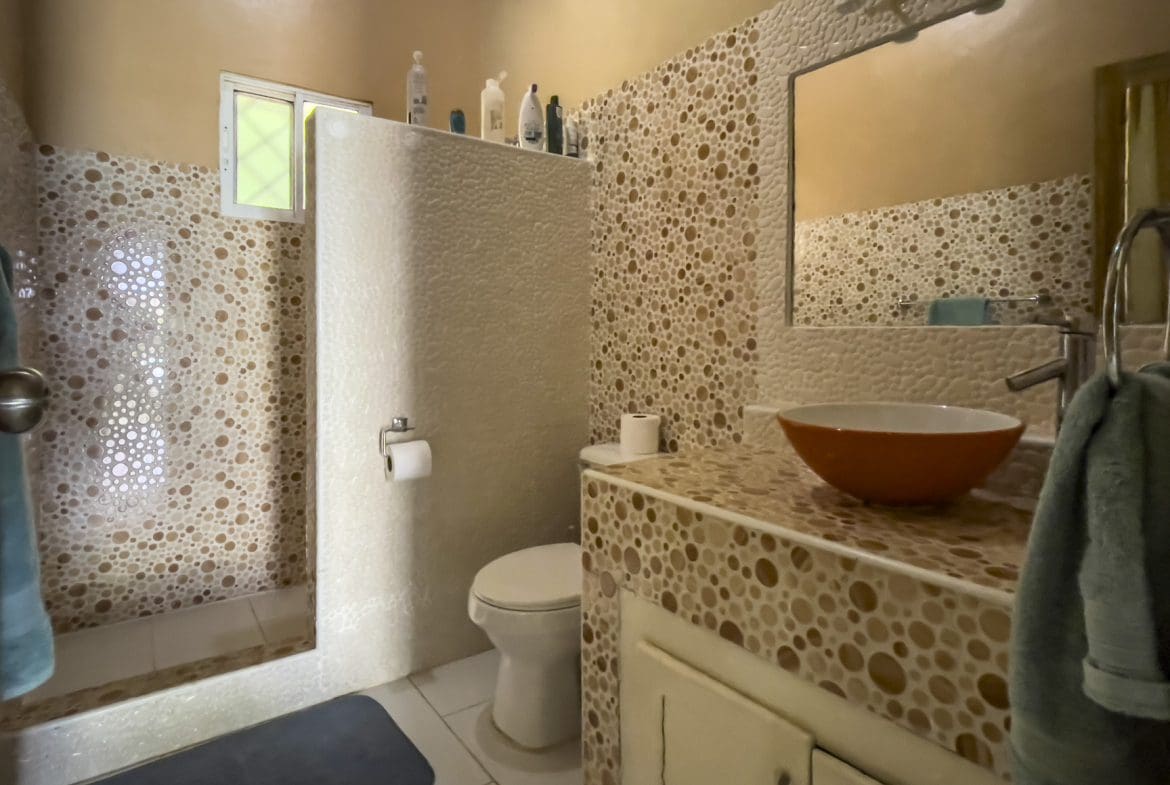 buyDRproperty Bathroom in a 3 bedroom villa for sale, featuring unique pebble tile design. Sosua Real Estate