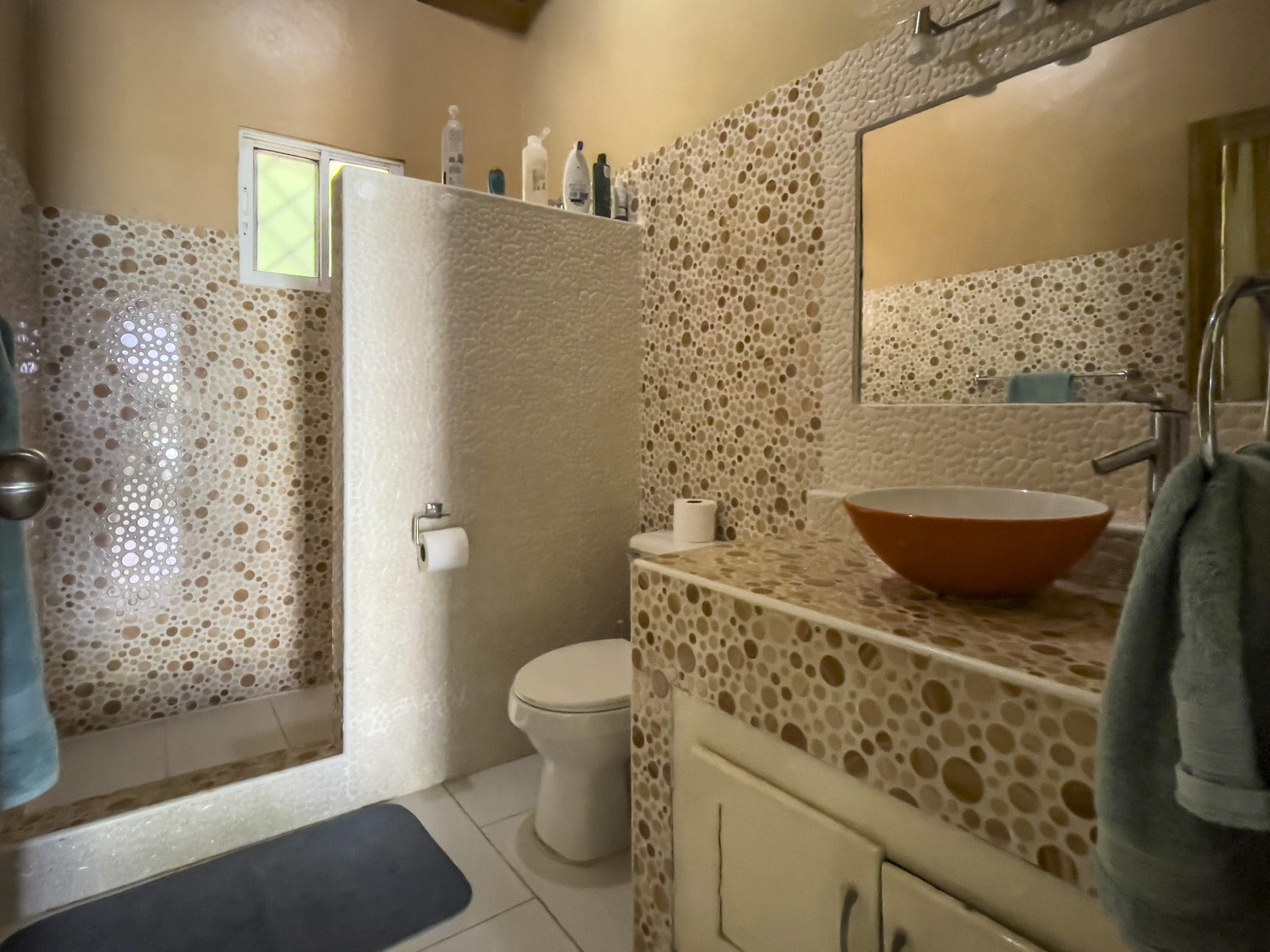 buyDRproperty Bathroom in a 3 bedroom villa for sale, featuring unique pebble tile design. Sosua Real Estate