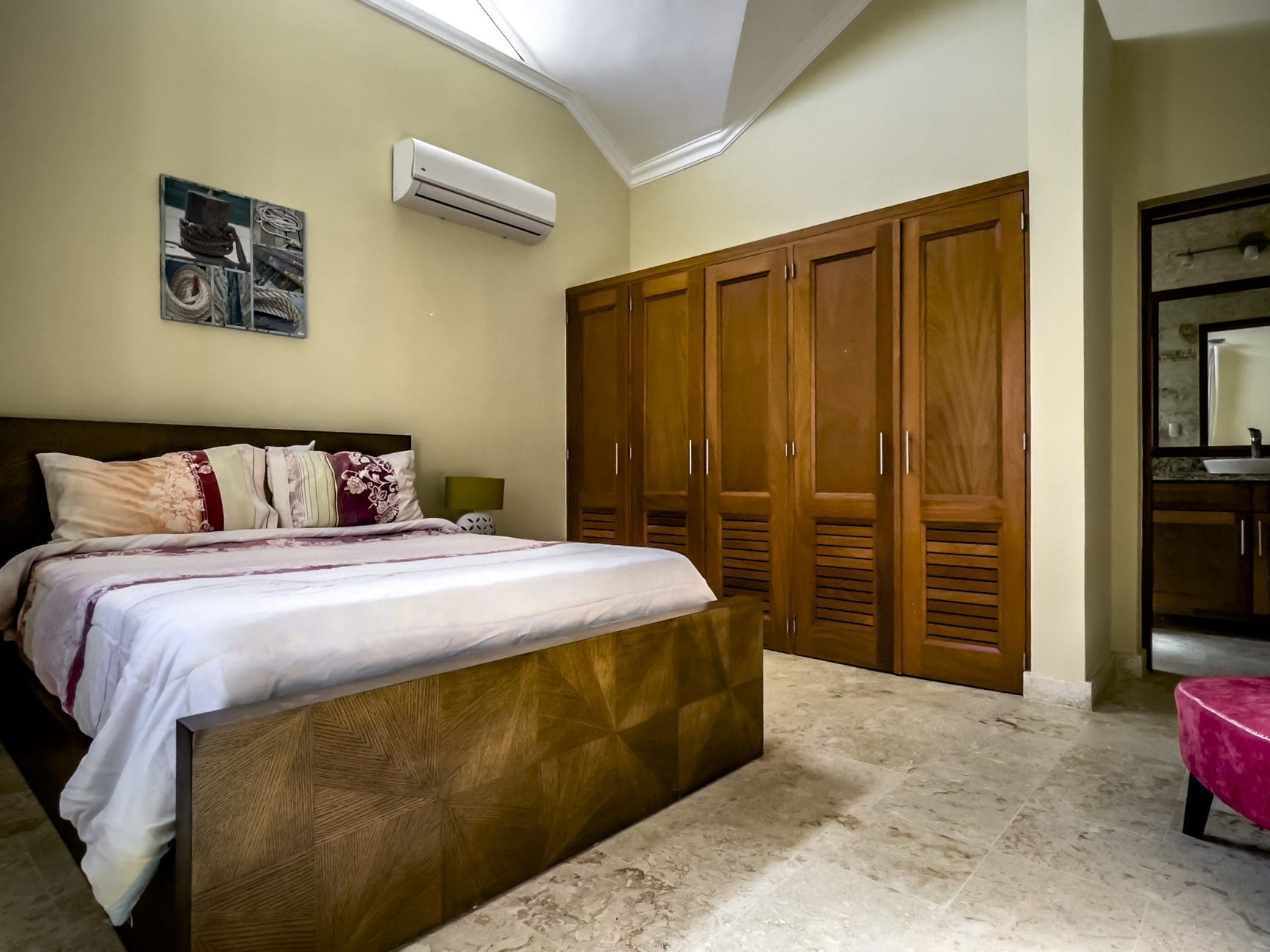 buyDRproperty Stunning 3 bedroom condo bedroom with wooden bed and closet Sosua Real Estate
