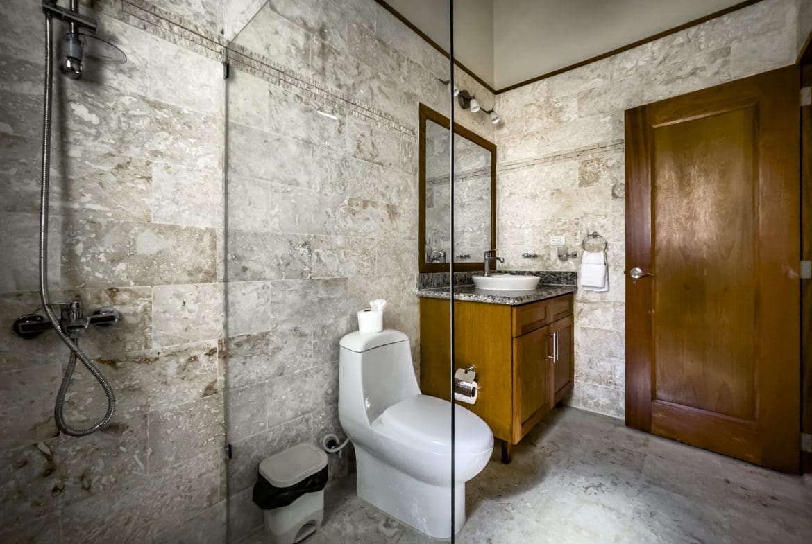 buyDRproperty Bathroom in a stunning 3 bedroom condo. Includes shower, toilet, and vanity. Sosua Real Estate