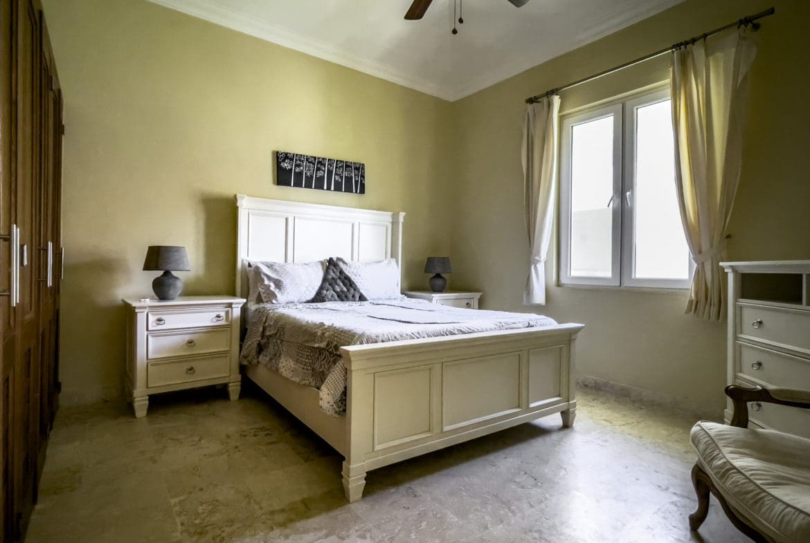 buyDRproperty Stunning 3 bedroom condo bedroom with white bed and nightstands. Sosua Real Estate