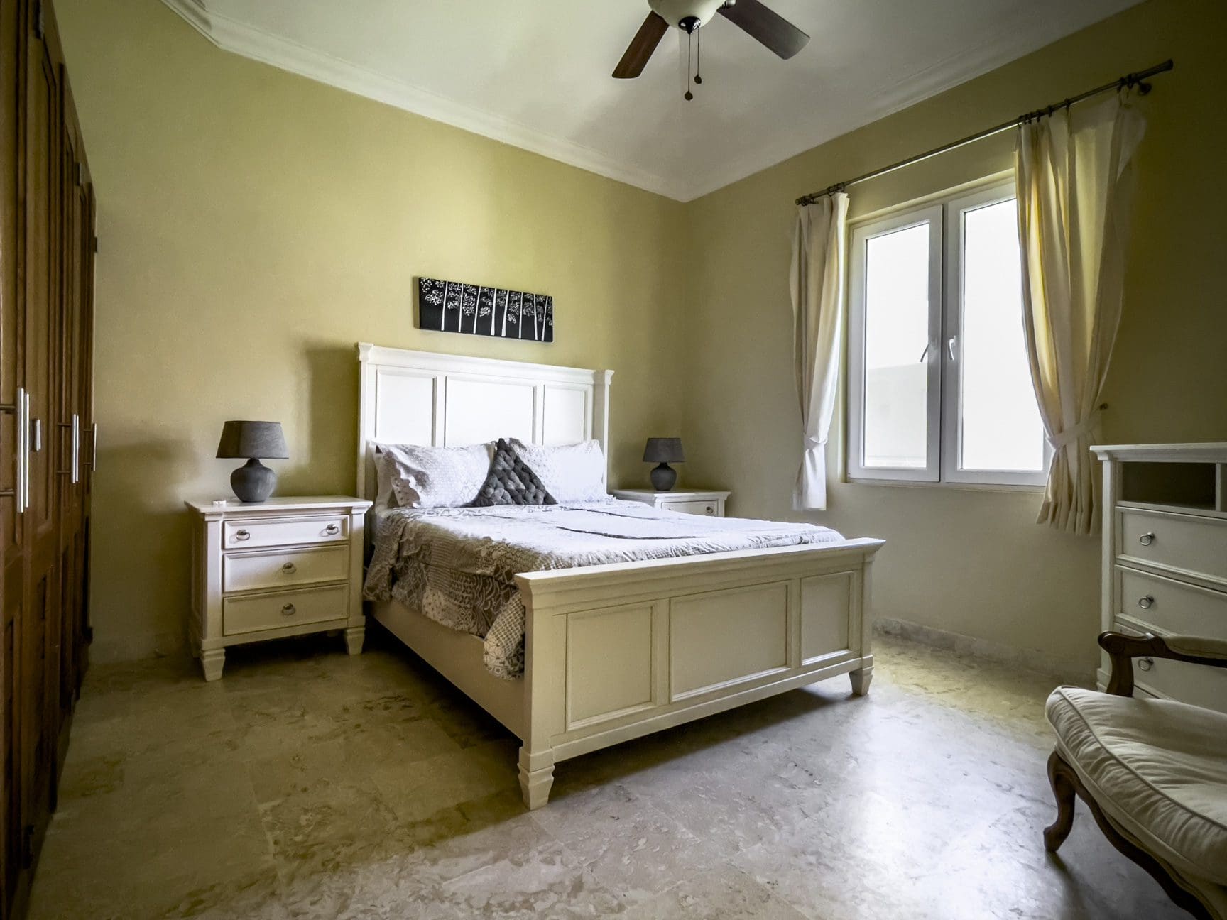 buyDRproperty Stunning 3 bedroom condo bedroom with white bed and nightstands. Sosua Real Estate