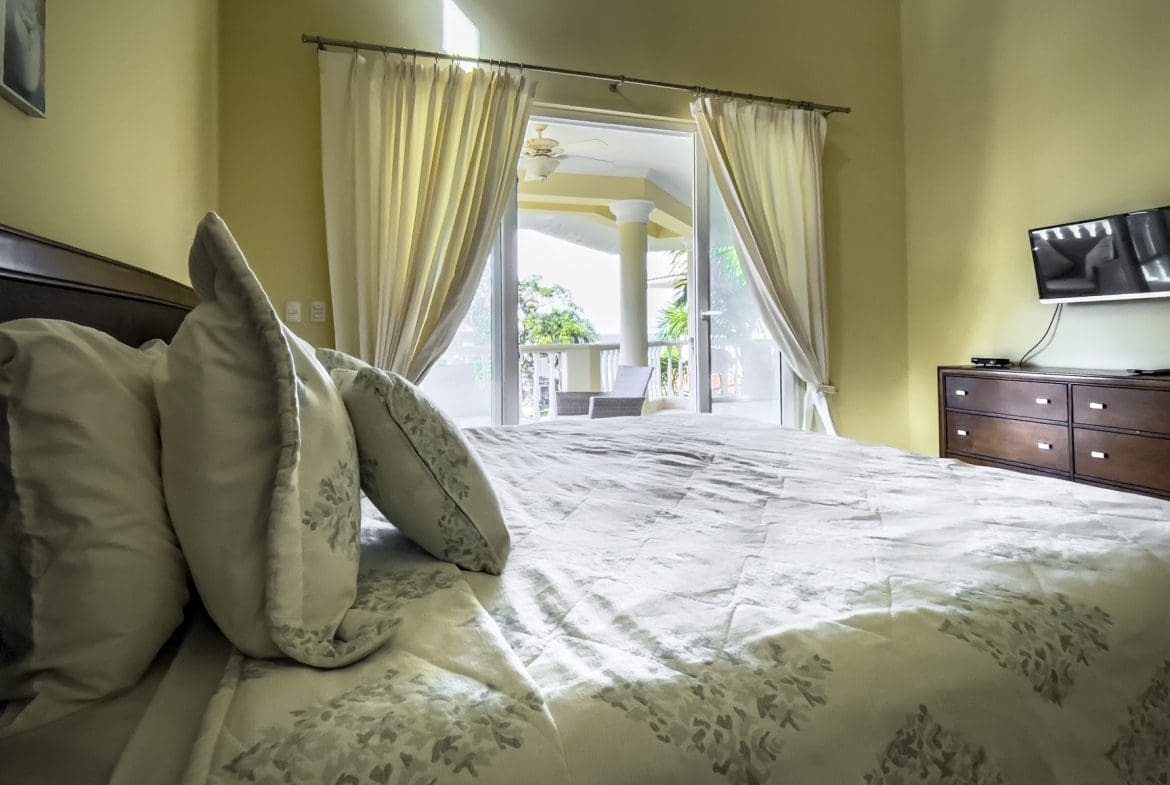 buyDRproperty Bedroom in a stunning 3 bedroom condo with a view of the balcony. Sosua Real Estate