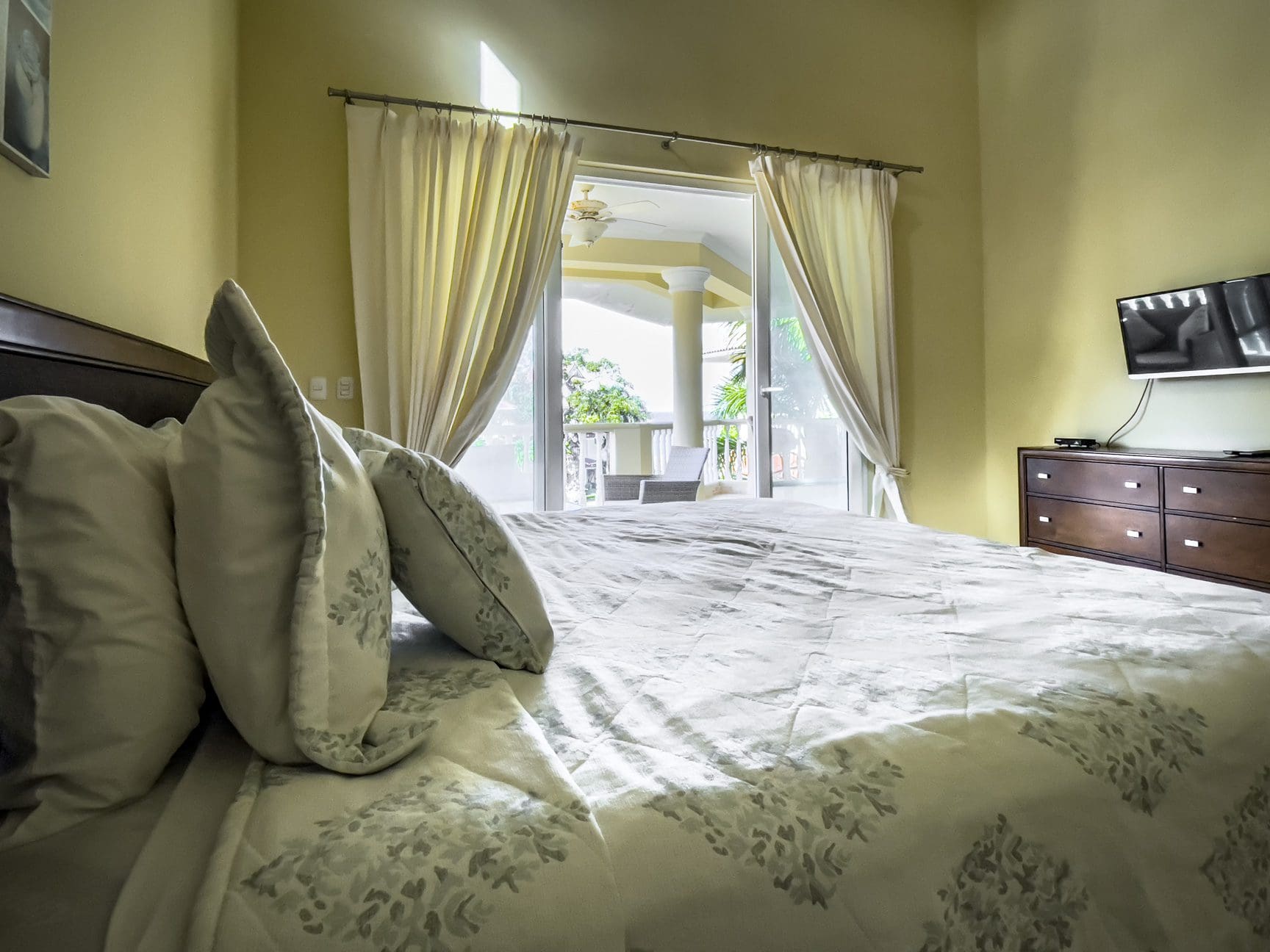 buyDRproperty Bedroom in a stunning 3 bedroom condo with a view of the balcony. Sosua Real Estate