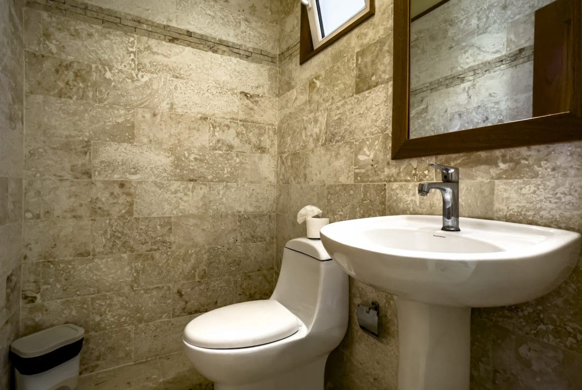 buyDRproperty Bathroom in a stunning 3 bedroom condo with stone tile walls. Sosua Real Estate