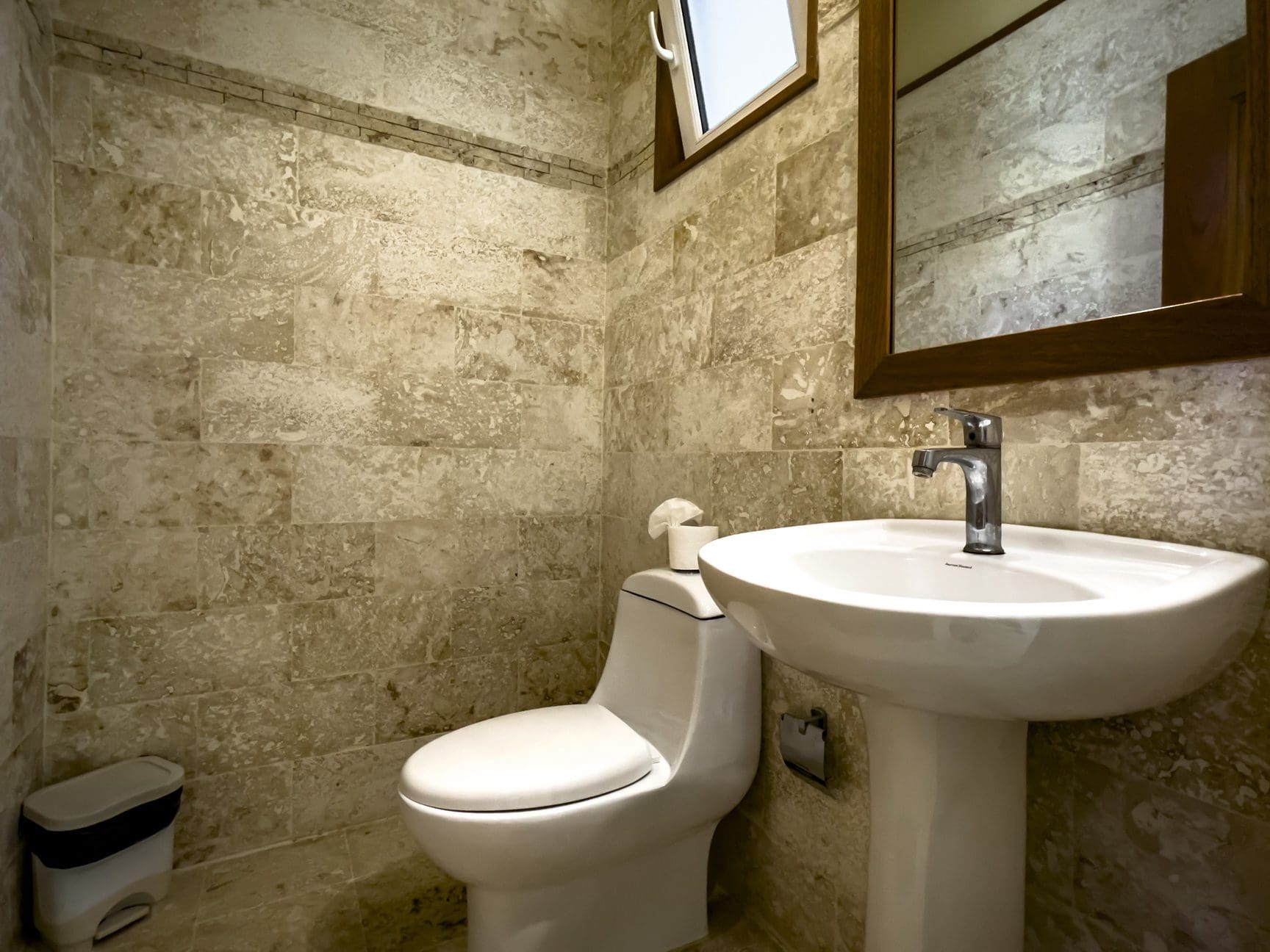 buyDRproperty Bathroom in a stunning 3 bedroom condo with stone tile walls. Sosua Real Estate