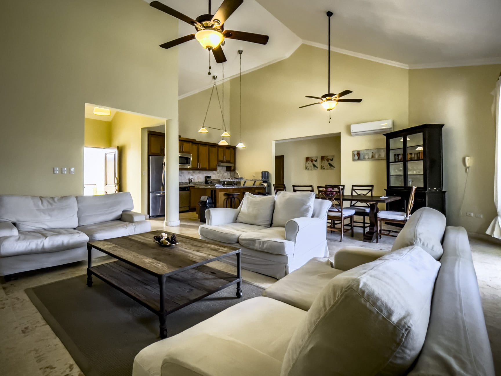buyDRproperty Spacious living room in a stunning 3 bedroom condo with high ceilings and light-colored furniture. Sosua Real Estate