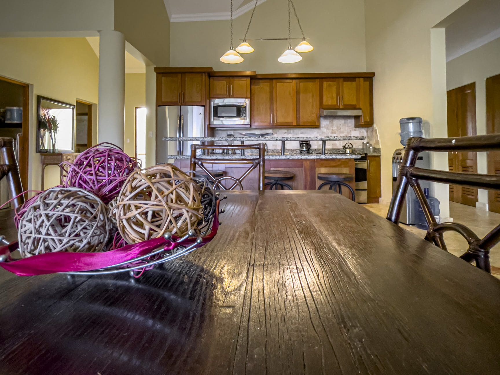 buyDRproperty Stunning 3 Bedroom Condo kitchen with wooden cabinets and decor on the table Sosua Real Estate