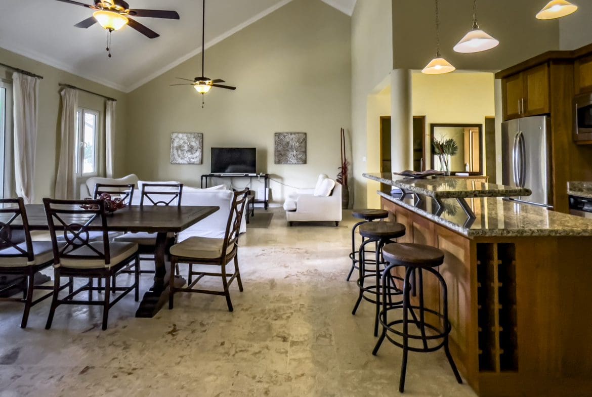 buyDRproperty Spacious living area of a stunning 3 bedroom condo with a kitchen island and dining table. Sosua Real Estate