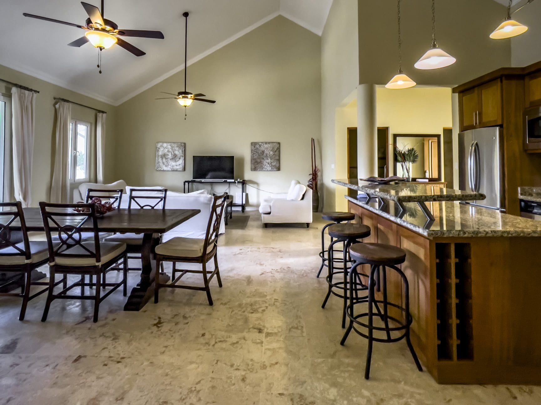 buyDRproperty Spacious living area of a stunning 3 bedroom condo with a kitchen island and dining table. Sosua Real Estate