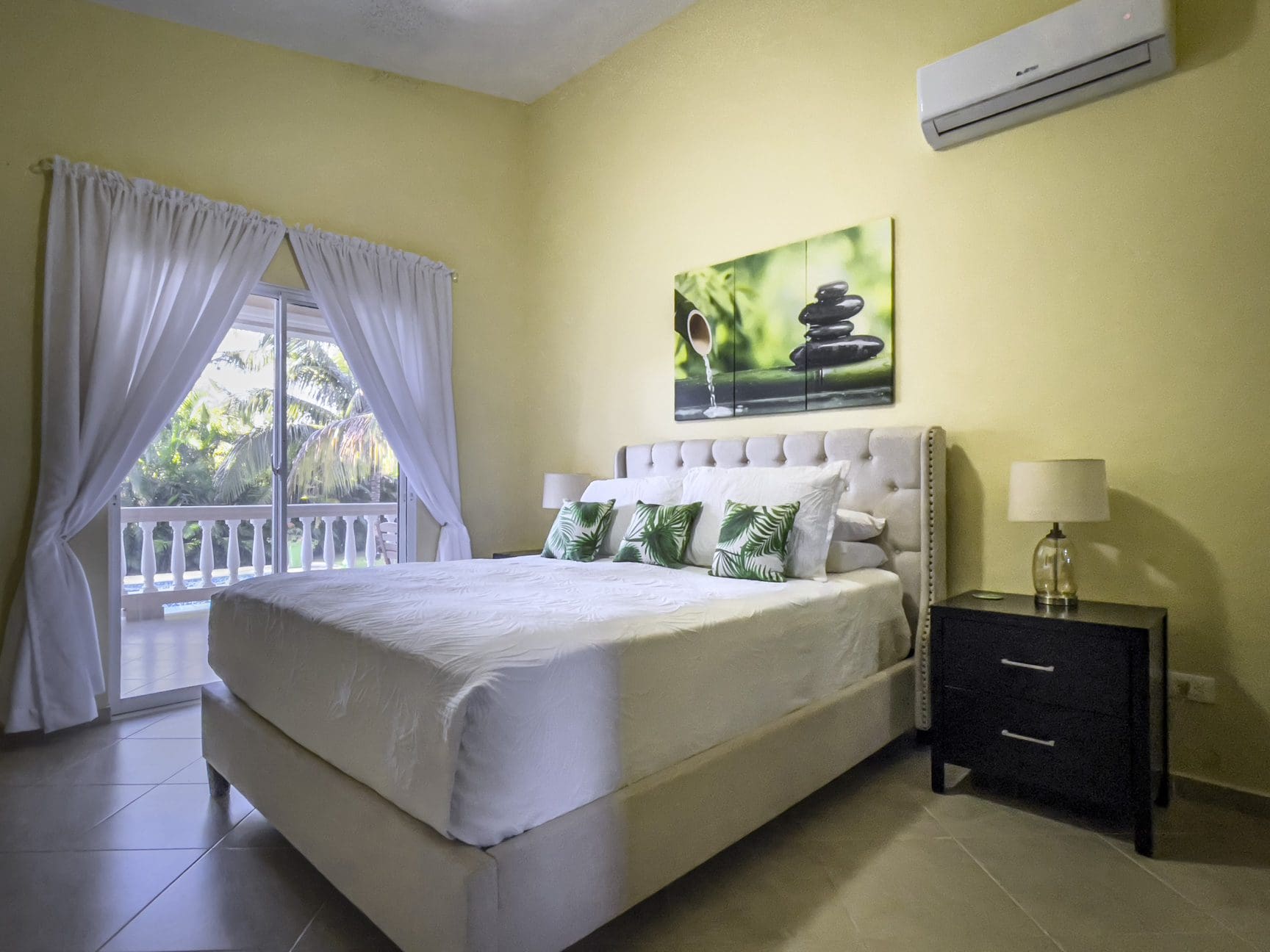 buyDRproperty Stunning 2 Bedroom Villa bedroom with a large bed and tropical decor. Sosua Real Estate