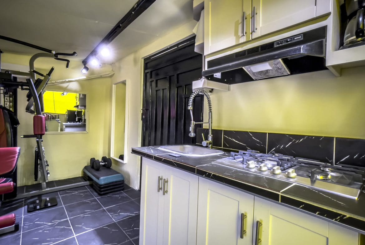 buyDRproperty Kitchen in a Smart Home For Sale! with stove, sink, and cabinets. Sosua Real Estate