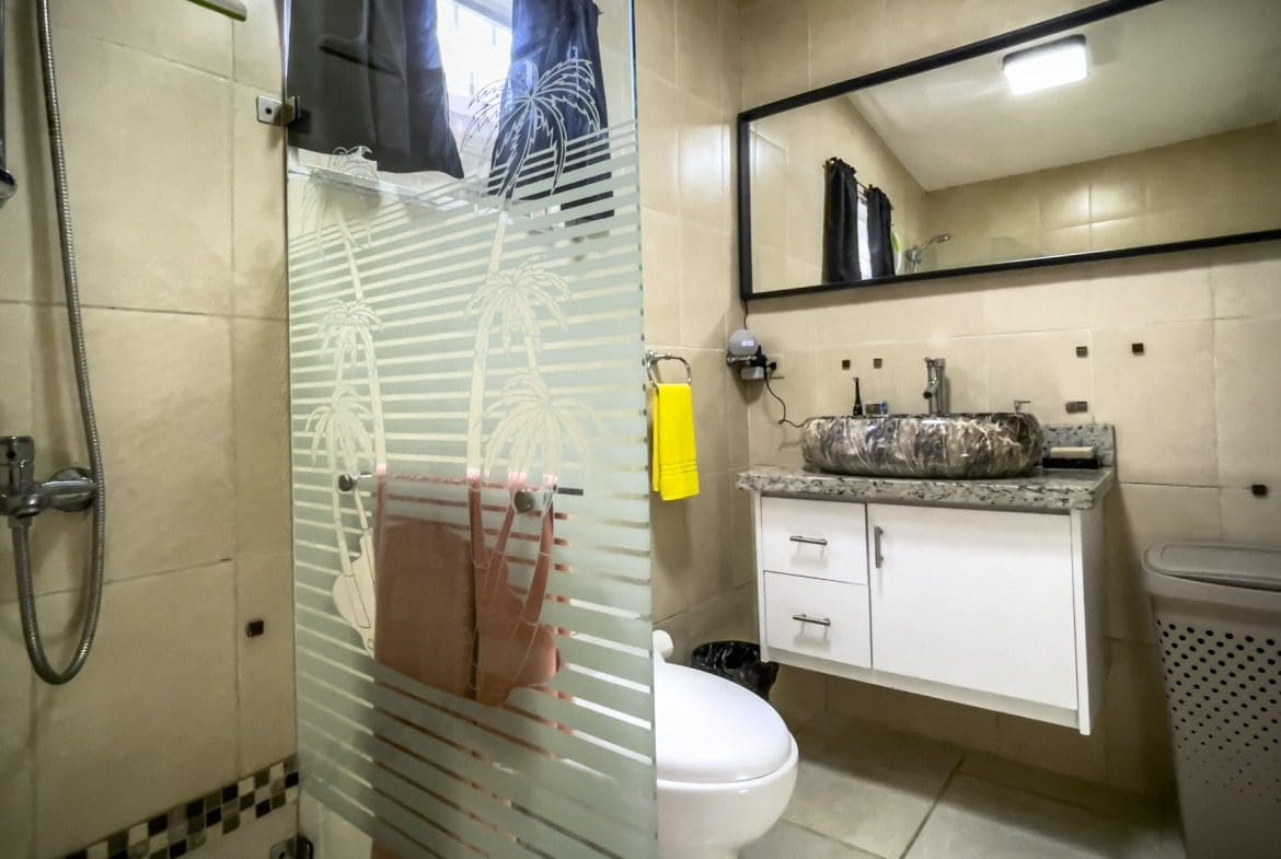 buyDRproperty Bathroom in a smart home for sale with a patterned glass shower door and a unique sink. Sosua Real Estate