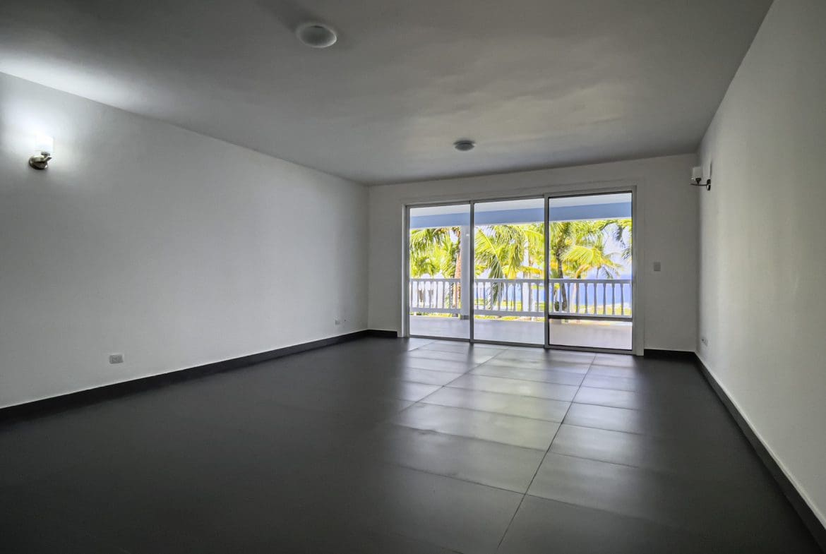 buyDRproperty Empty oceanfront 2 bedroom condo with ocean views and sliding glass doors Sosua Real Estate