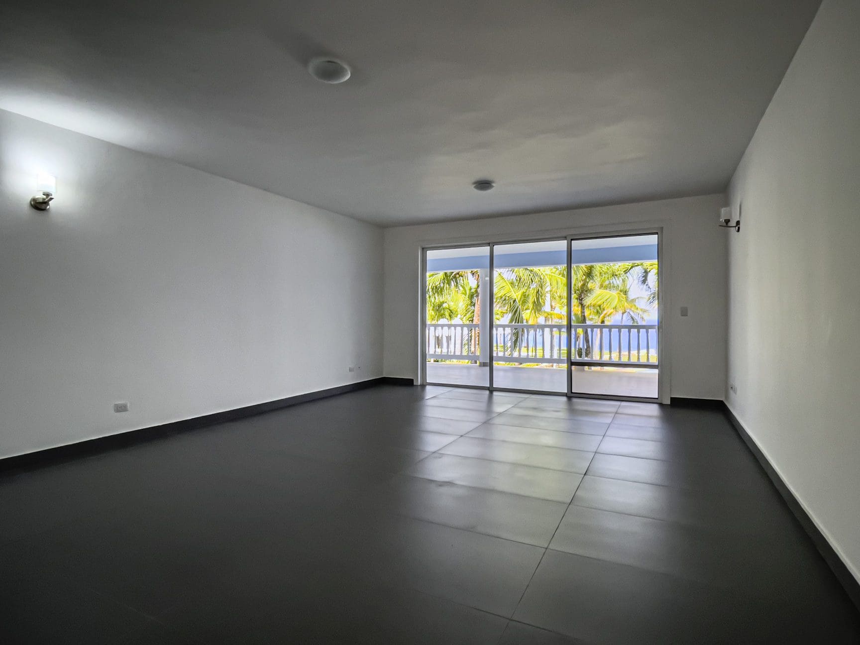 buyDRproperty Empty oceanfront 2 bedroom condo with ocean views and sliding glass doors Sosua Real Estate