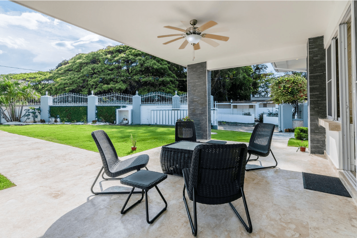 buyDRproperty Outdoor patio with black wicker furniture at a gorgeous 5 bedroom villa. Sosua Real Estate