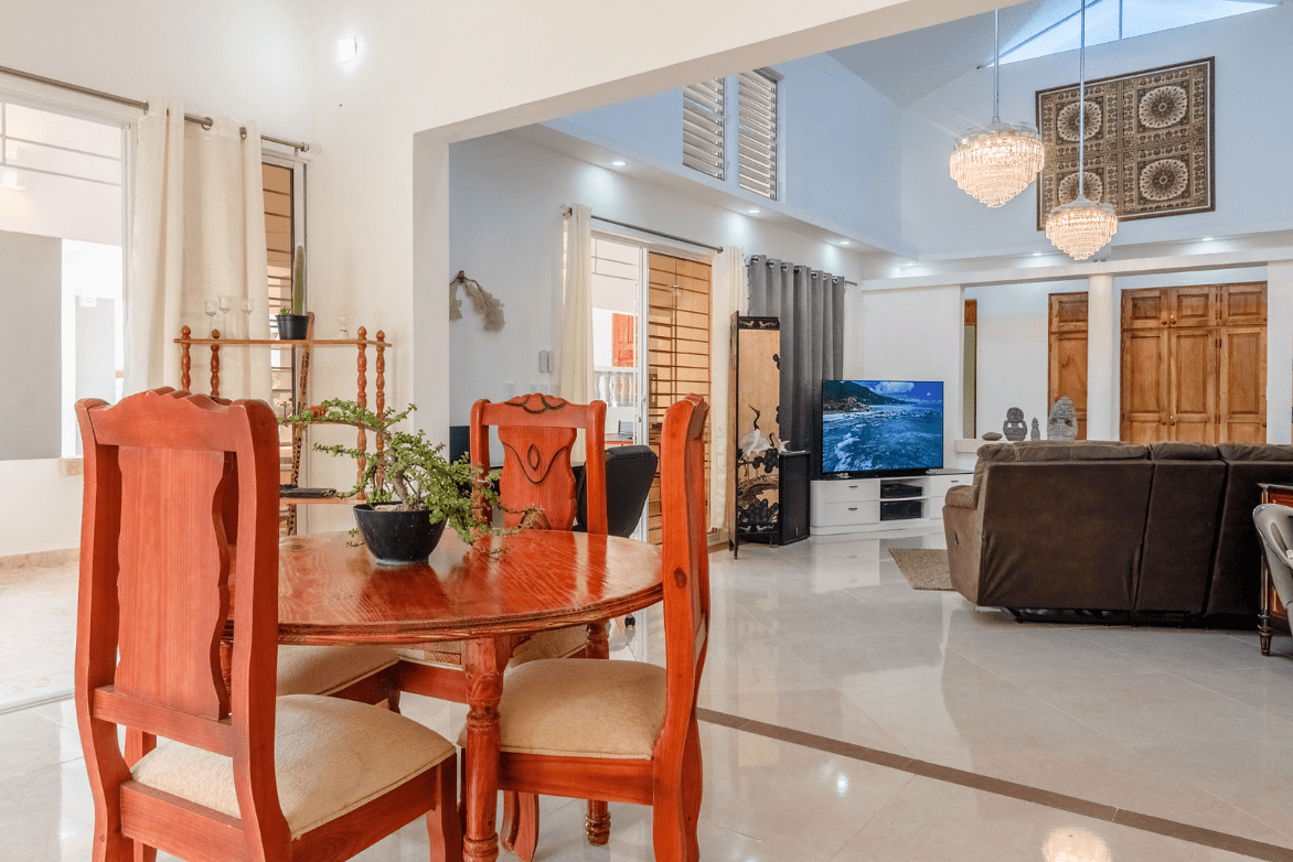 buyDRproperty Dining area of a gorgeous 5 bedroom villa with round wooden table and chairs. Sosua Real Estate
