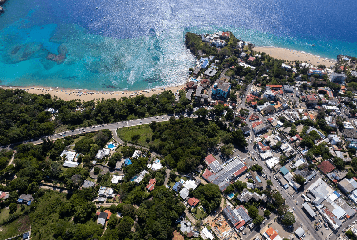 buyDRproperty Aerial view of a coastal town with a beach and the gorgeous 5 bedroom villa for sale. Sosua Real Estate