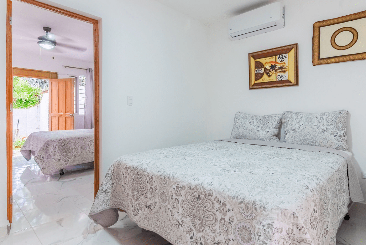 buyDRproperty Bedroom in a gorgeous 5 bedroom villa with a view of another bed Sosua Real Estate