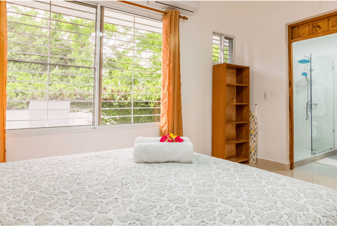 buyDRproperty Bedroom in a gorgeous 5 bedroom villa with a view of the trees and a shower. Sosua Real Estate
