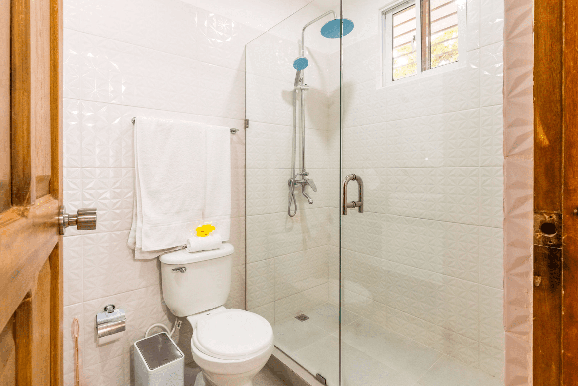 buyDRproperty Bathroom with white tile and a glass shower in a Gorgeous 5 Bedroom Villa. Sosua Real Estate