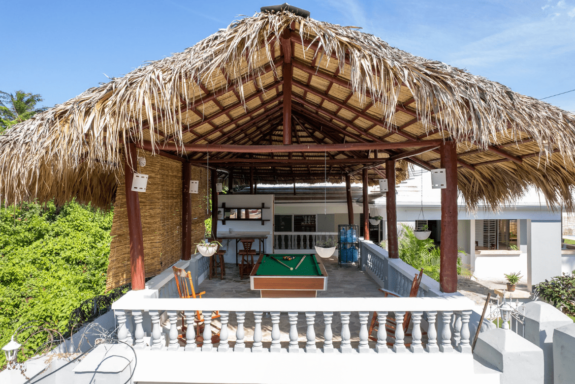 buyDRproperty Gorgeous 5 Bedroom Villa: Outdoor games area with pool table under a thatched roof. Sosua Real Estate