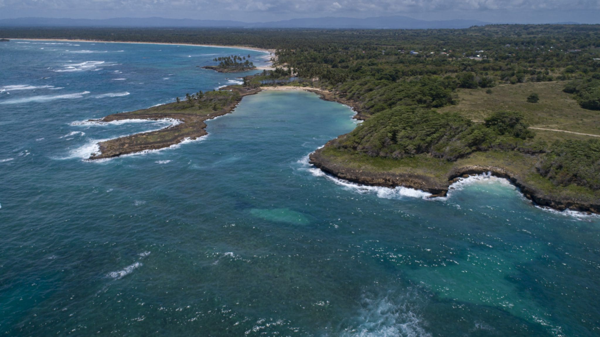 buyDRproperty Aerial view of oceanfront development property with potential marina, showing coastline and bay. Sosua Real Estate