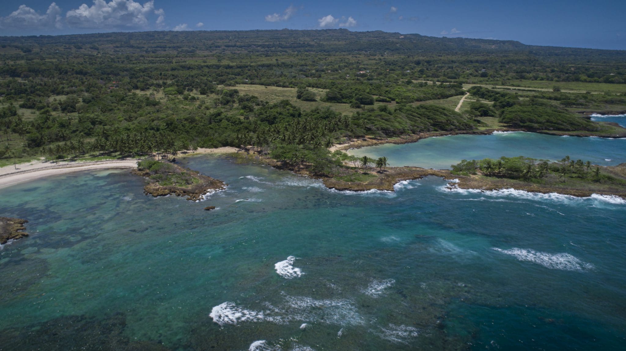 buyDRproperty Aerial view of oceanfront development property with potential marina, showcasing a beautiful coastline. Sosua Real Estate