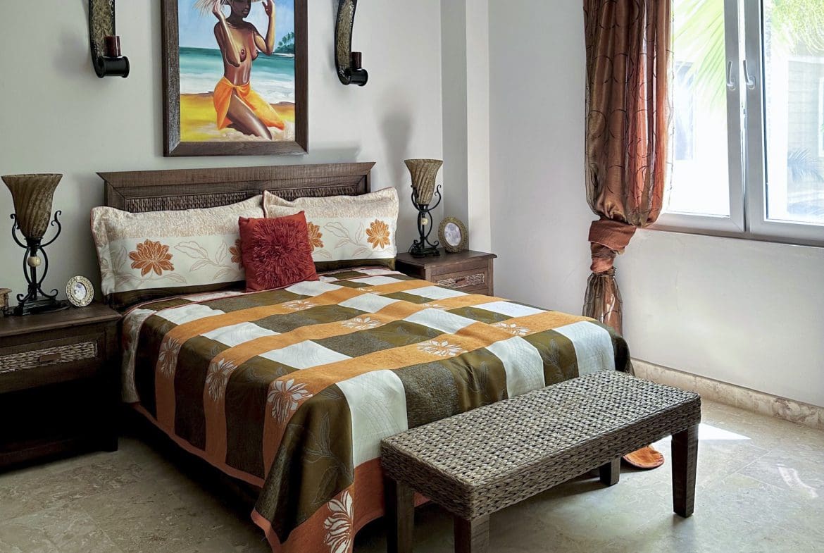 buyDRproperty Bedroom in a Sosua condo for sale with warm color scheme Sosua Real Estate