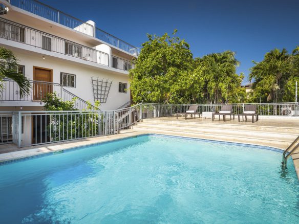 buyDRproperty Modern penthouse for sale in Sosua with pool and lounge chairs. Sosua Real Estate