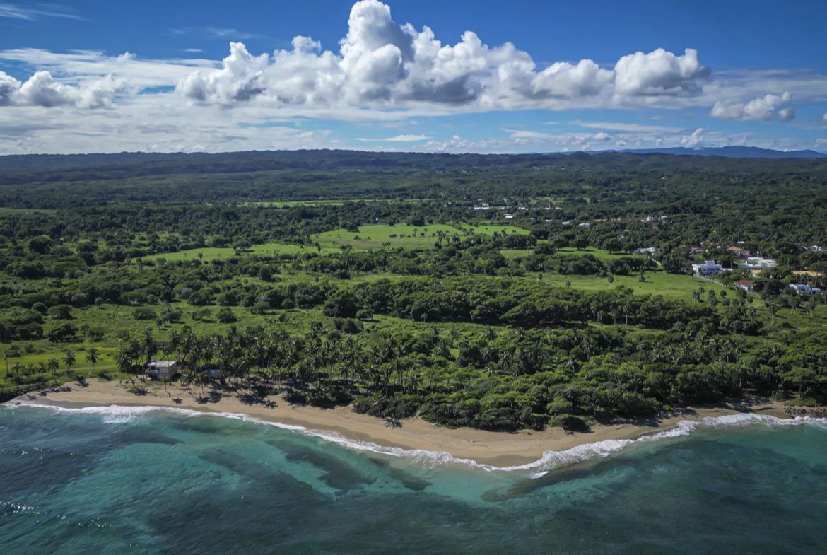 buyDRproperty Aerial view of stunning oceanfront development property with turquoise water and lush green landscape Sosua Real Estate