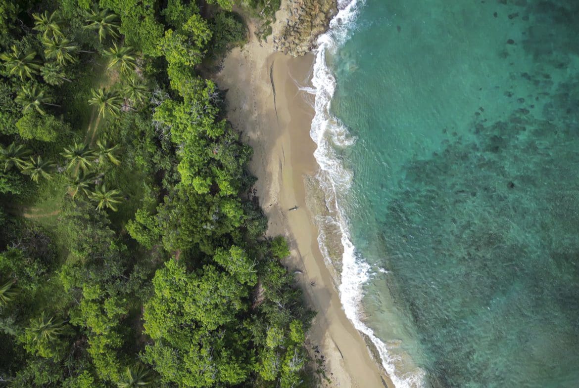 buyDRproperty Aerial view of stunning oceanfront development property with beach and turquoise water Sosua Real Estate