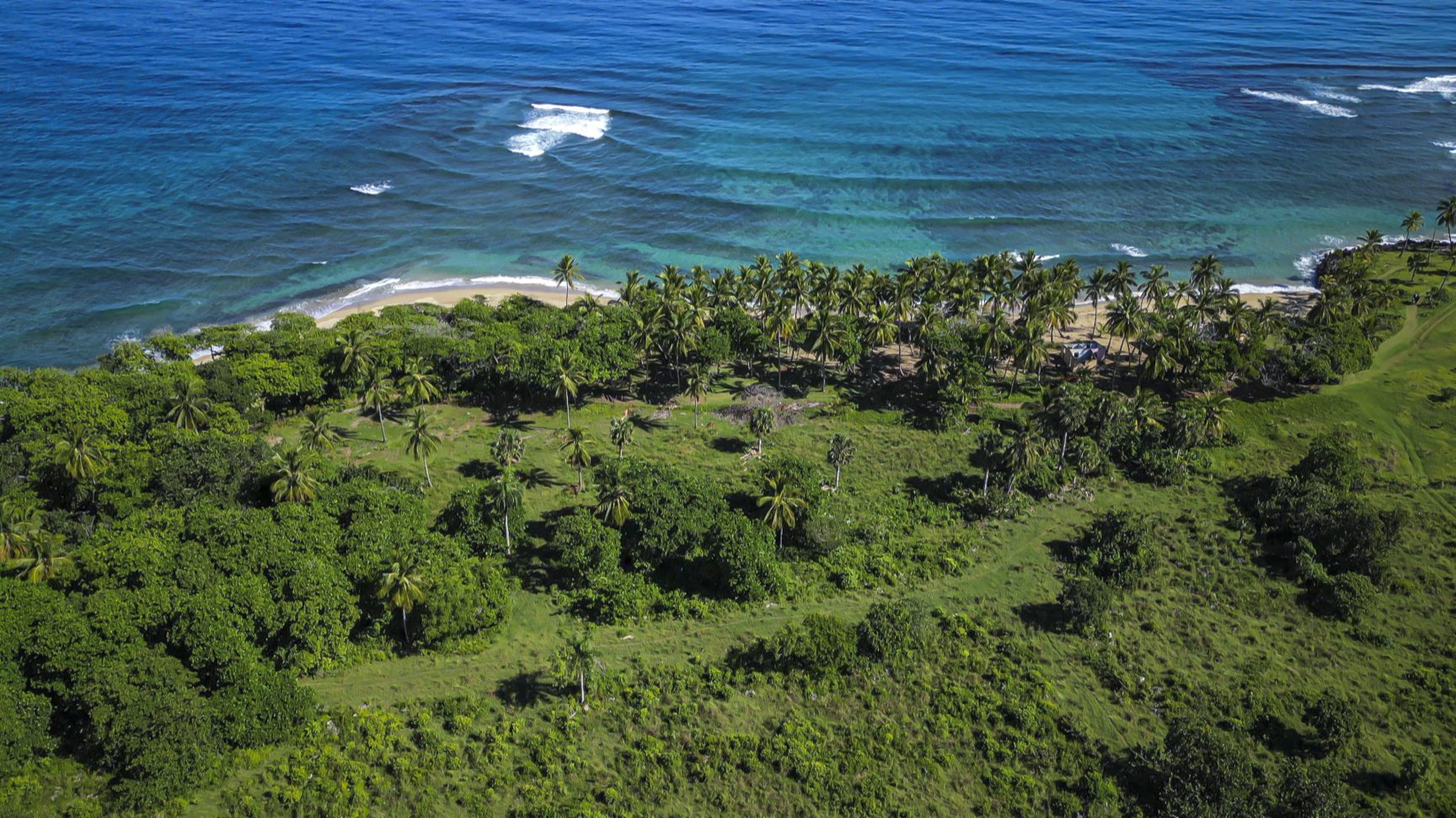 buyDRproperty Stunning oceanfront development property with sandy beach and palm trees. Sosua Real Estate