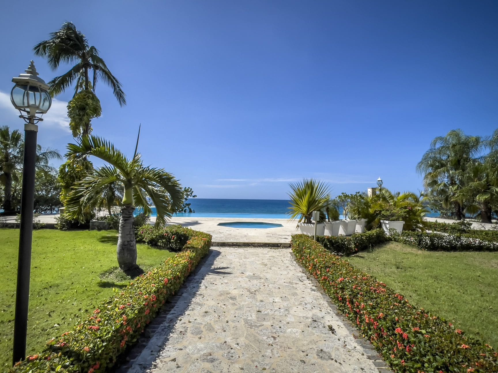buyDRproperty Oceanfront view from a pathway leading to a pool, Sosua, Dominican Republic. Sosua Real Estate