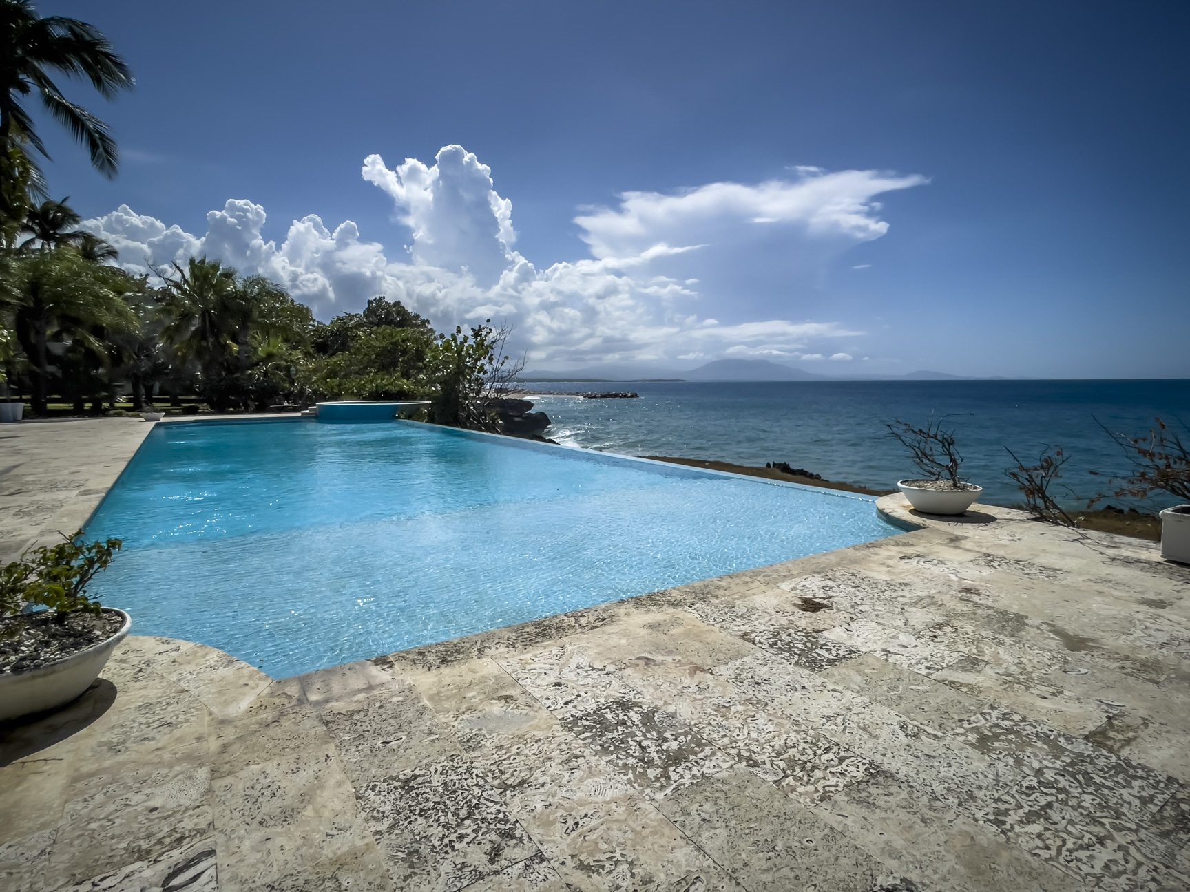 buyDRproperty Infinity pool overlooking the ocean with a beautiful view. Sosua oceanfront condo for sale. Sosua Real Estate