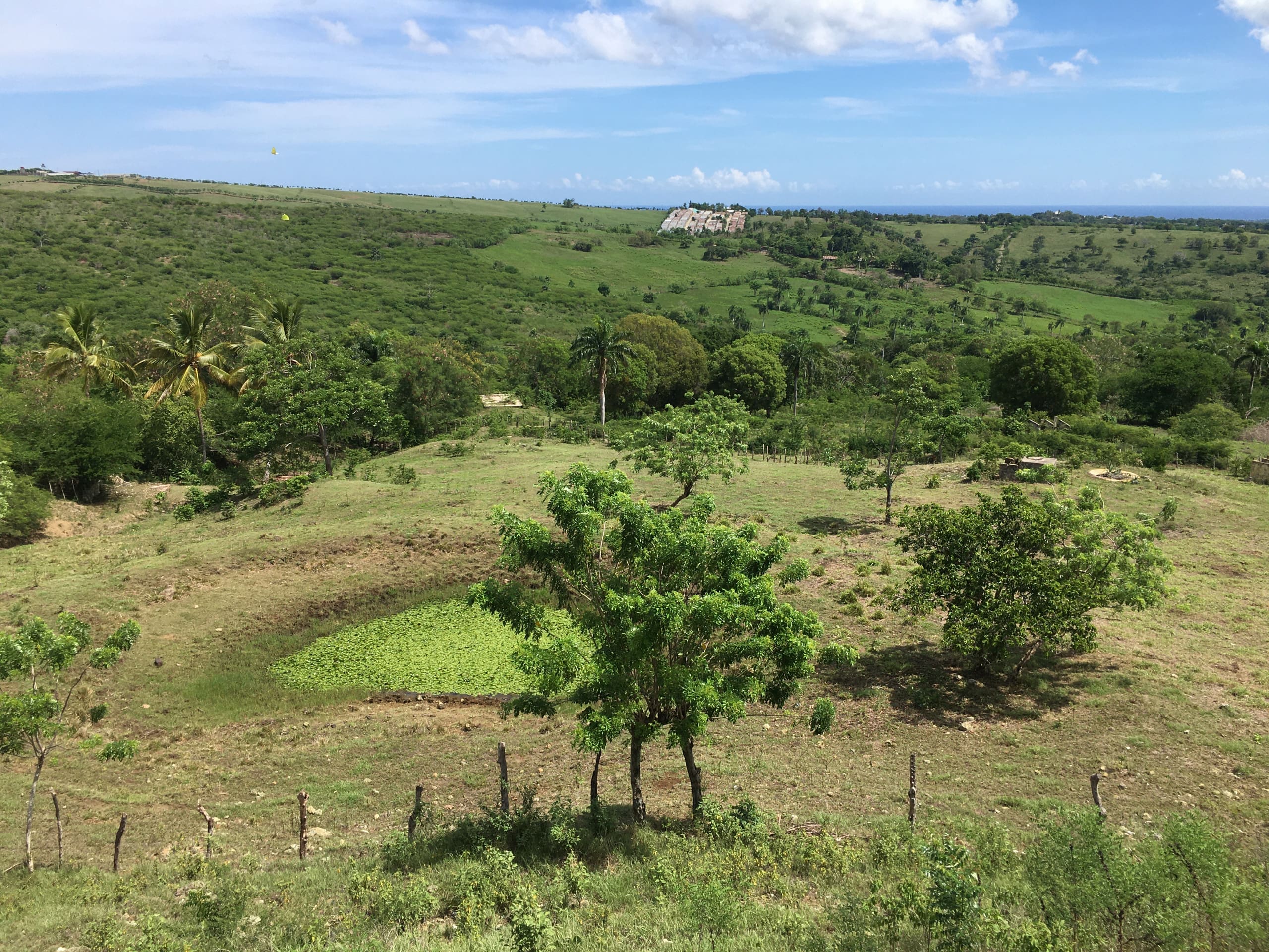 buyDRproperty Expansive green development property with lush landscapes under a blue sky Sosua Real Estate