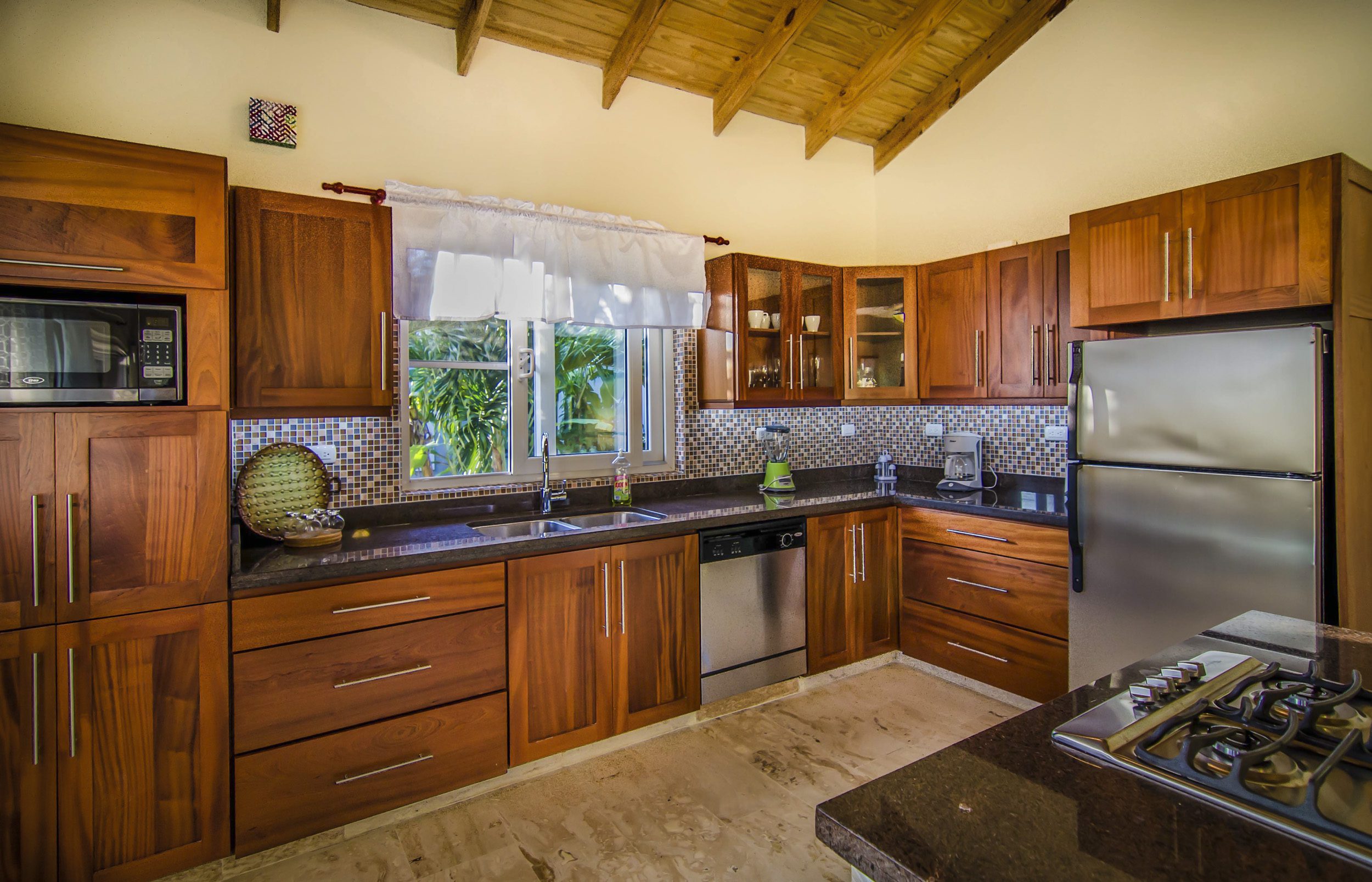 buyDRproperty Elegant wooden kitchen with stainless steel appliances, a villa for sale in the Community of Terramar. Sosua Real Estate
