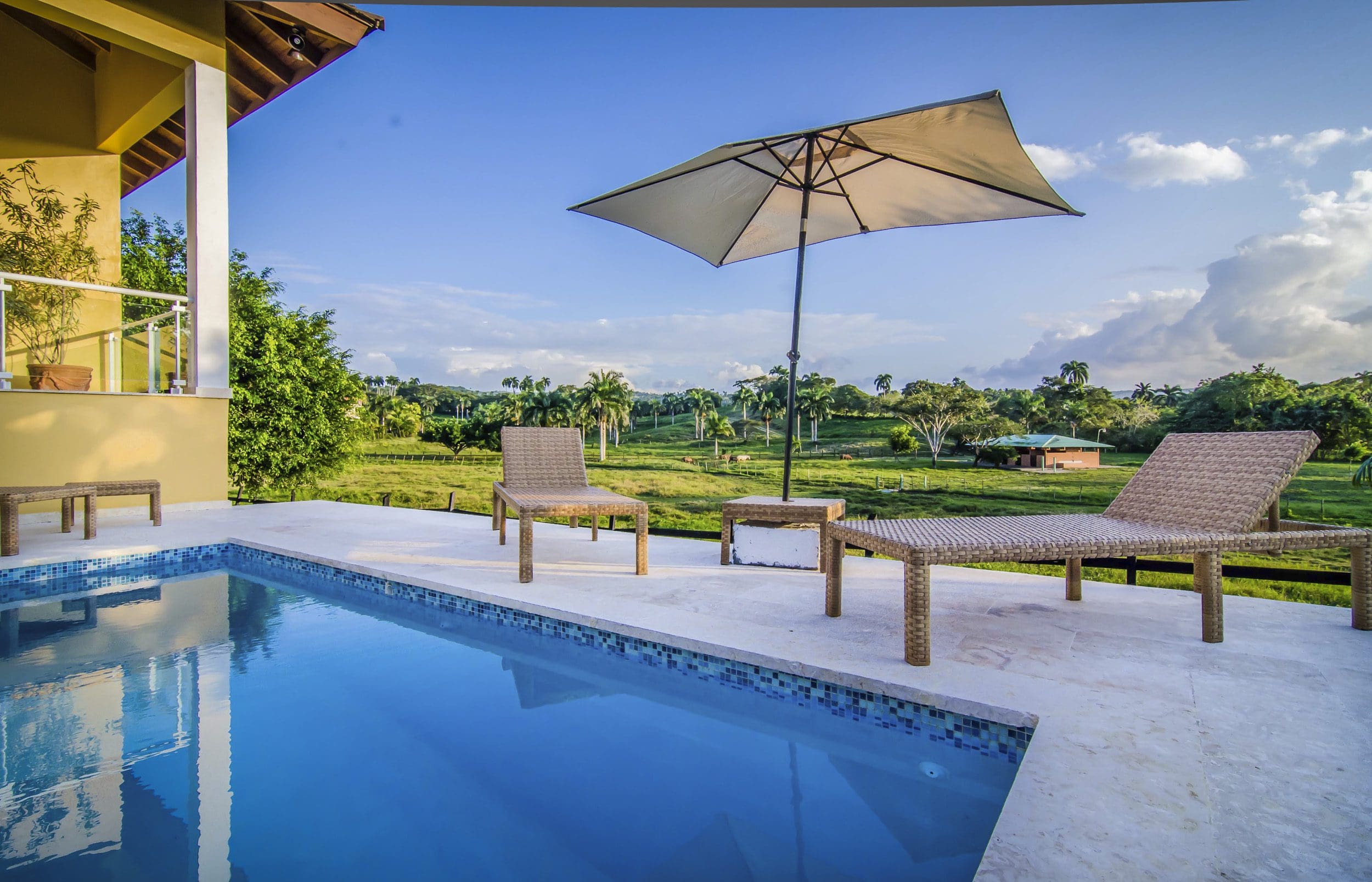 buyDRproperty Luxury villa for sale in the Community of Terramar with swimming pool and relaxing outdoor seating. Sosua Real Estate