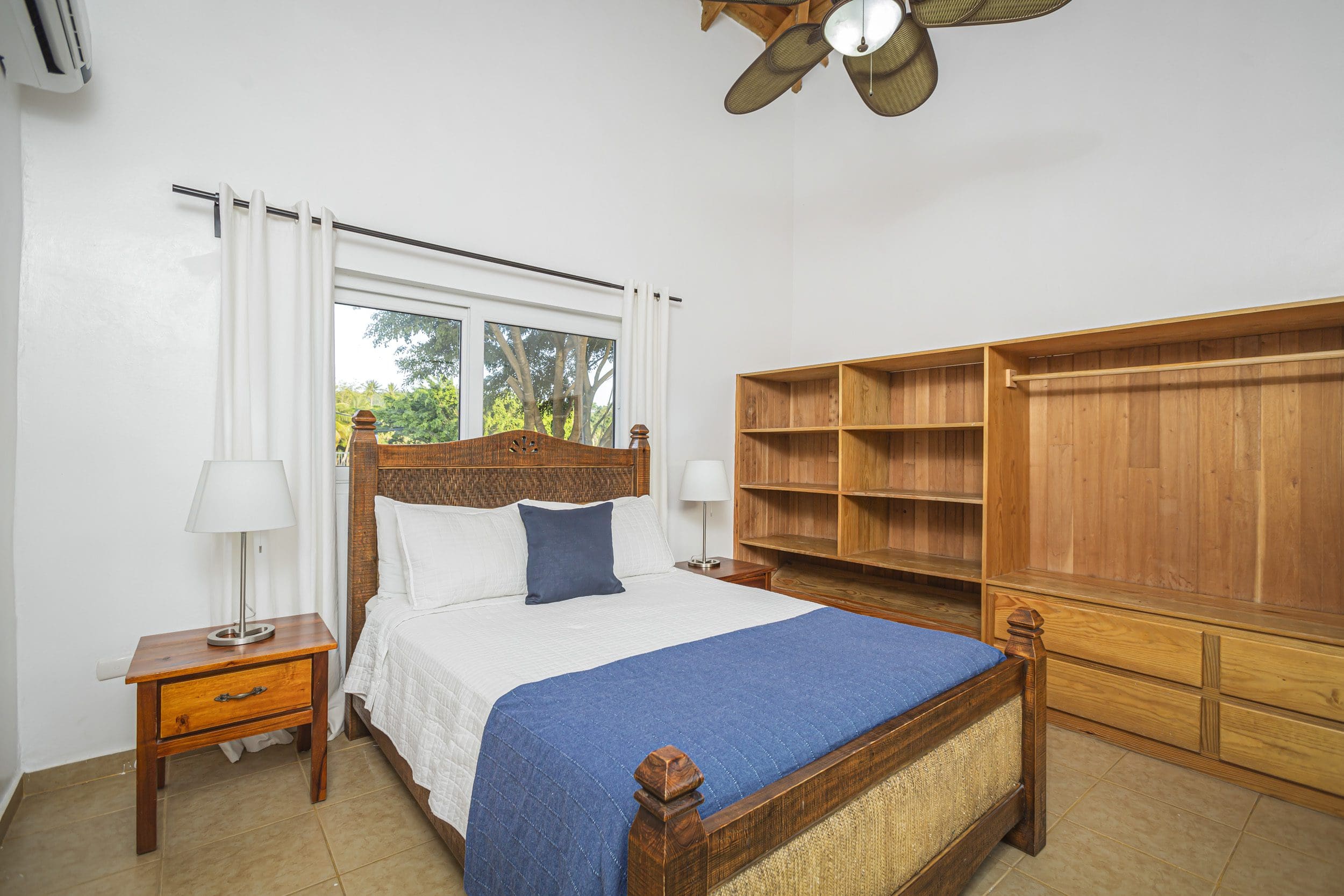 buyDRproperty Bedroom of a Villa For Sale in the Community Of Terramar, featuring a wooden bed and wardrobe. Sosua Real Estate