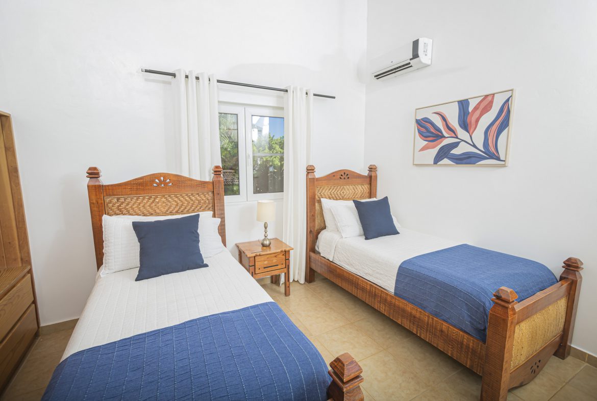 buyDRproperty Bedroom in a Villa For Sale in the Community Of Terramar with two single beds and art. Sosua Real Estate