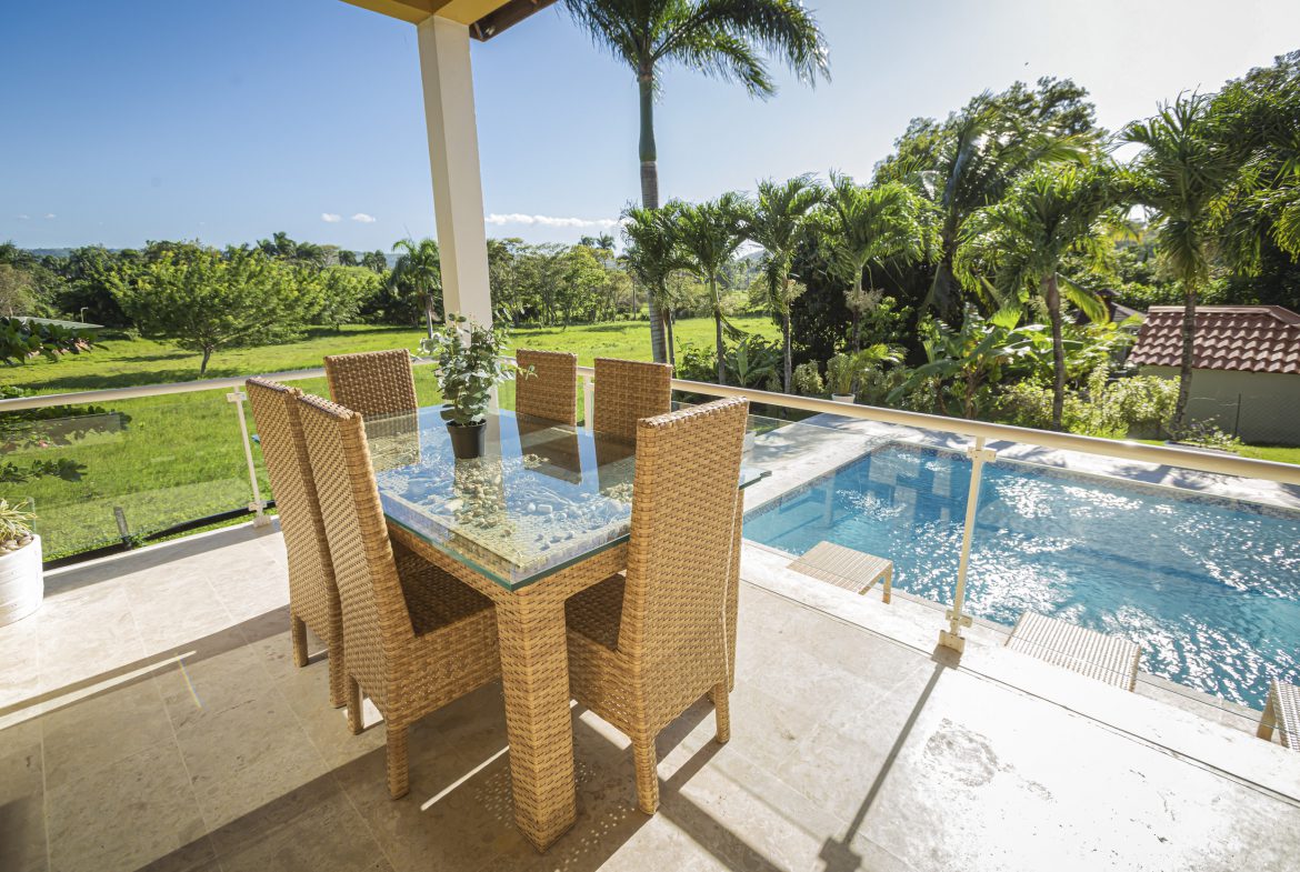 buyDRproperty Outdoor dining area with pool view at a villa. Sosua Real Estate