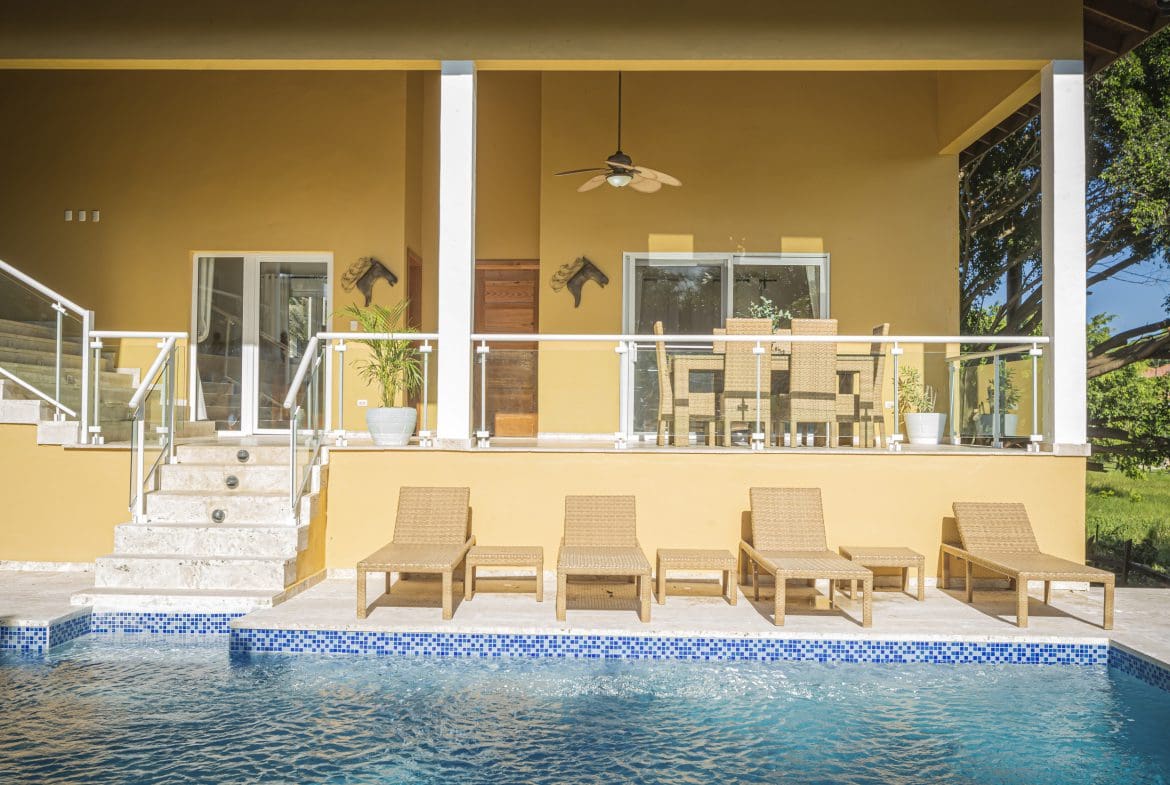 buyDRproperty Luxury villa for sale in the Community of Terramar with a pool and outdoor seating. Sosua Real Estate