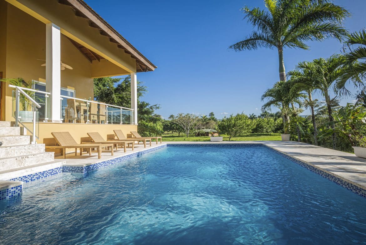buyDRproperty Luxury villa for sale in the Community of Terramar with a private pool and palm trees. Sosua Real Estate