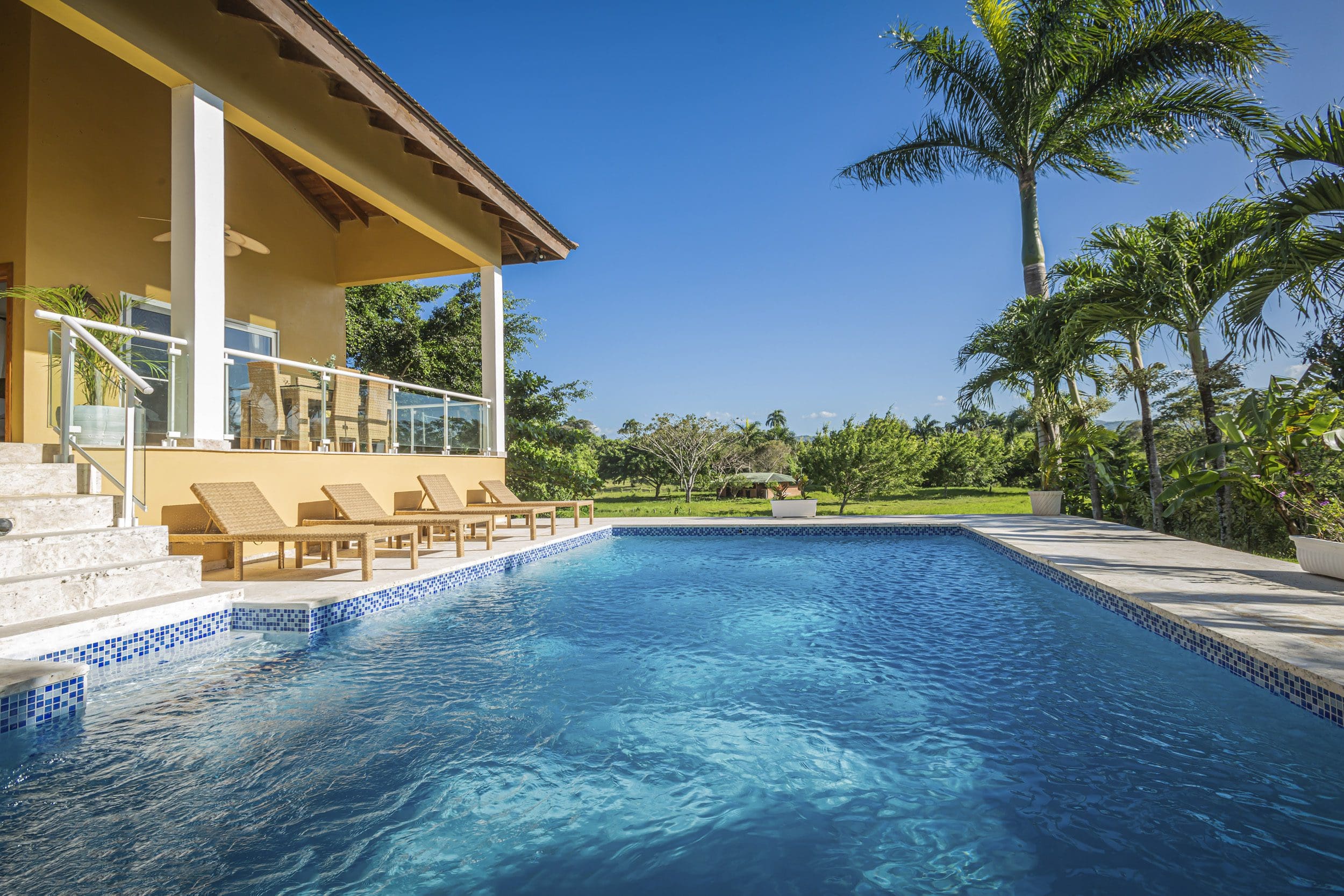 buyDRproperty Luxury villa for sale in the Community of Terramar with a private pool and palm trees. Sosua Real Estate