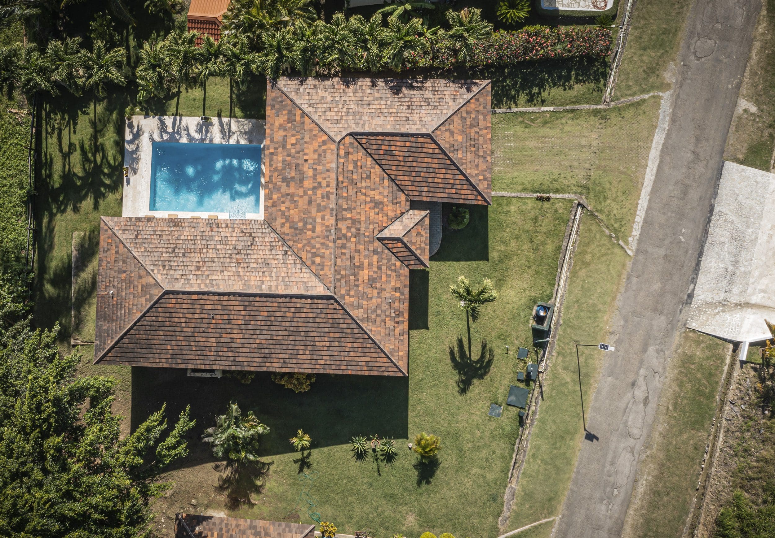 buyDRproperty Aerial view of a villa for sale in the Community of Terramar with a pool and lush landscaping. Sosua Real Estate